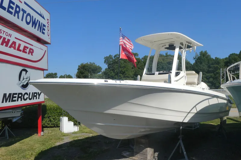 The Image of 2025 Boston Whaler 220 Dauntless boat displayed outdoors with American flag. - 0