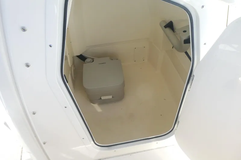 Slide: The Image of Interior of 2025 Boston Whaler 220 Dauntless boat with portable toilet. - 16