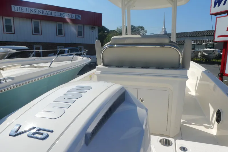 Slide: The Image of 2025 Boston Whaler 220 Dauntless boat with V6 engine, showcased at dealership. - 4