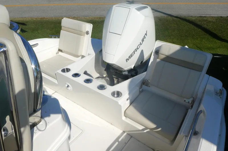 Slide: The Image of 2025 Boston Whaler 220 Dauntless boat with Mercury engine and seating area. - 9