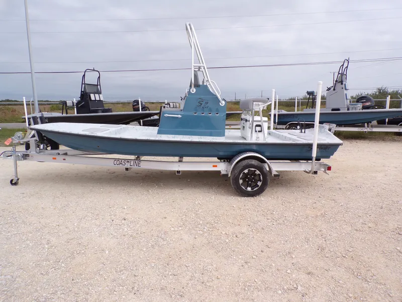 Slide: The Image of 2025 Shoalwater 19 CAT boat on trailer, displayed outdoors. - 1