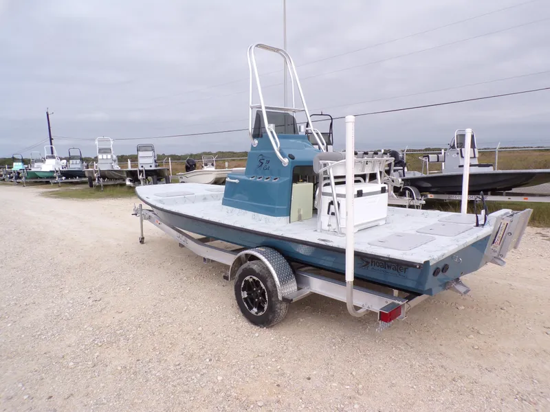 Slide: The Image of 2025 Shoalwater 19 CAT boat on trailer, parked outdoors. - 12