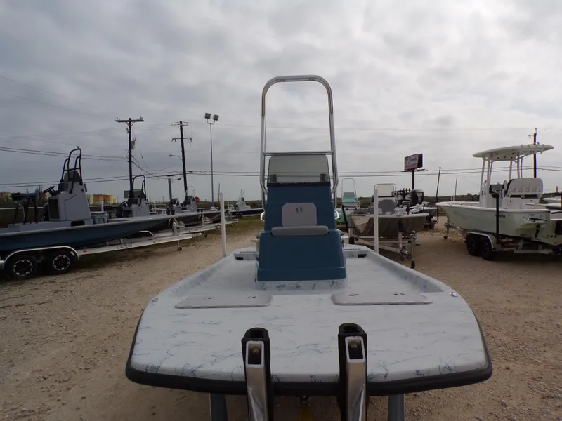 Slide: The Image of 2025 Shoalwater 19 CAT boat displayed outdoors on a gravel lot. - 15