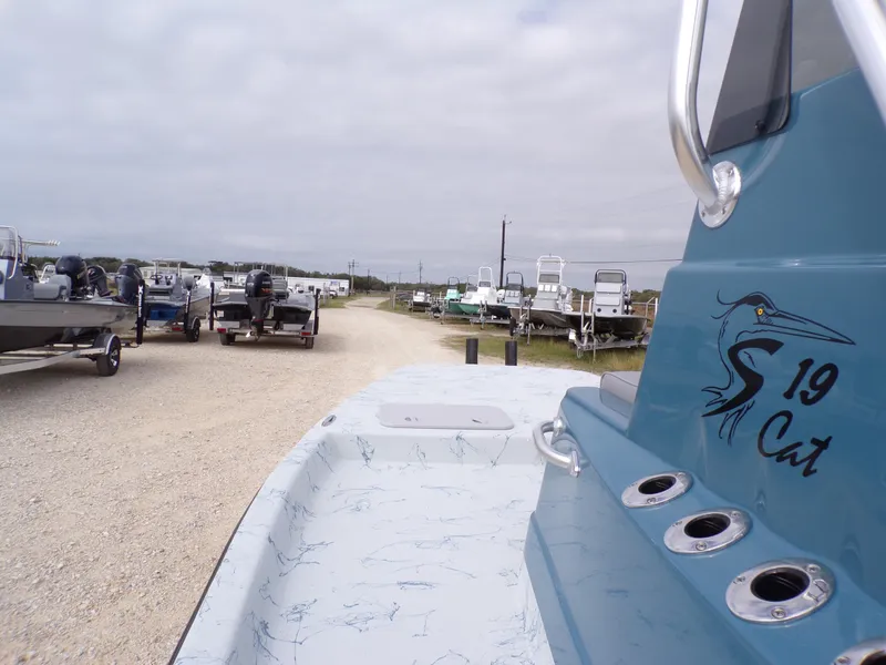 Slide: The Image of 2025 Shoalwater 19 CAT boat in a marina with other vessels. - 17