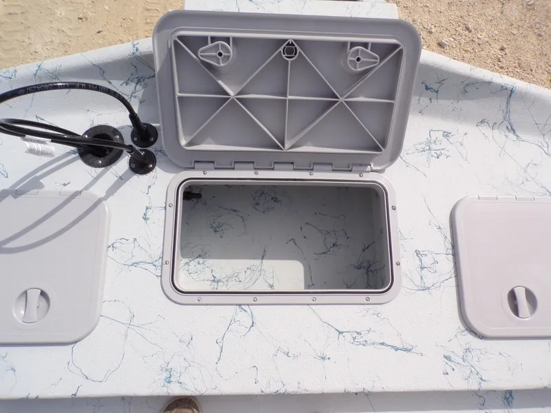 Slide: The Image of Open storage compartment on 2025 Shoalwater 19 CAT boat deck. - 28