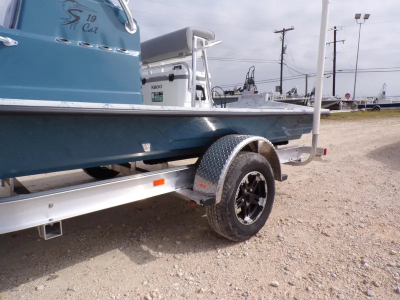 Slide: The Image of 2025 Shoalwater 19 CAT boat on trailer, side view, blue hull, outdoor setting. - 31