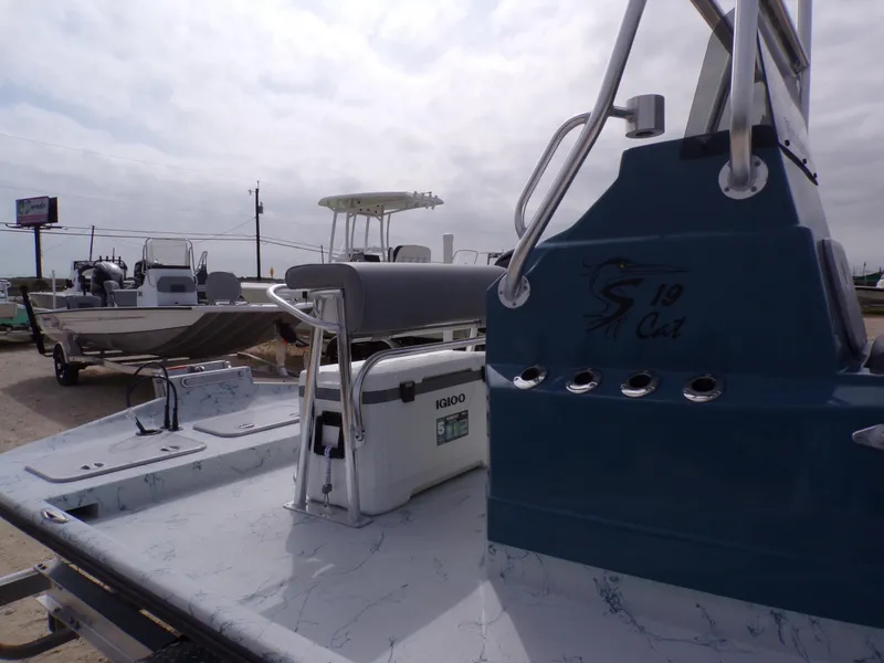 Slide: The Image of Shoalwater 19 CAT 2025 boat with Igloo cooler on deck, parked outdoors. - 32