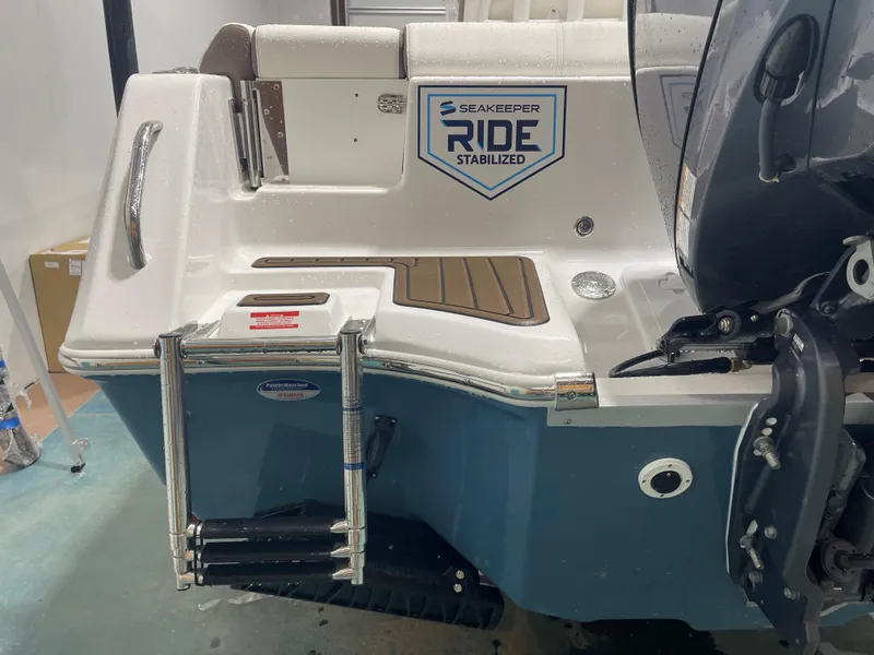 Slide: The Image of 2025 Tidewater 232LXF boat with Seakeeper Ride stabilization and swim ladder. - 10