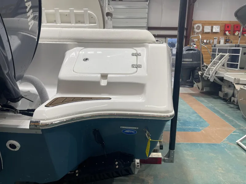 Slide: The Image of 2025 Tidewater 232LXF boat in showroom, featuring Yamaha engine and sleek design. - 11