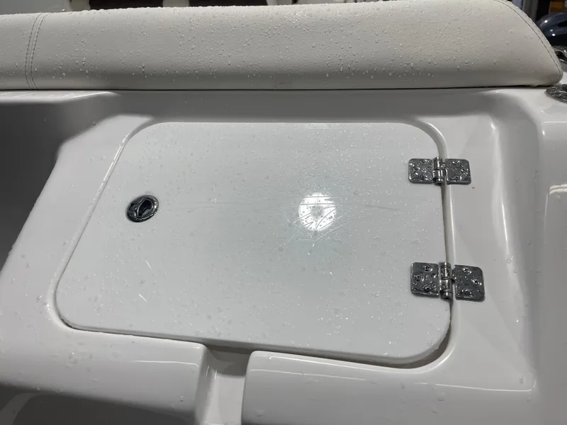 Slide: The Image of 2025 Tidewater 232LXF boat compartment with water droplets and stainless steel hinges. - 15