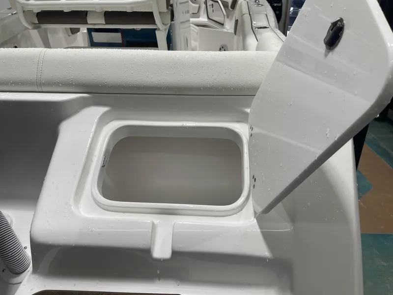 Slide: The Image of Open storage compartment on 2025 Tidewater 232LXF boat, showcasing interior details. - 16