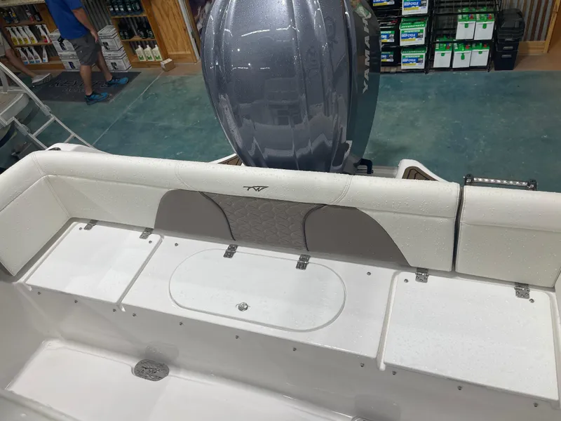 Slide: The Image of 2025 Tidewater 232LXF boat interior with Yamaha engine, displayed in a showroom. - 17
