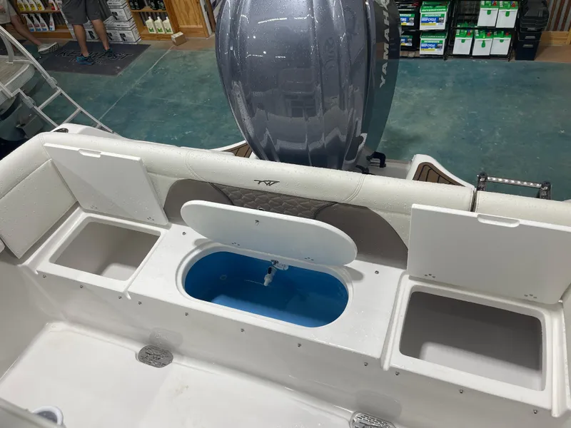 Slide: The Image of 2025 Tidewater 232LXF boat interior with storage compartments and Yamaha engine. - 18