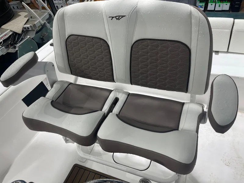Slide: The Image of 2025 Tidewater 232LXF boat seat with gray and brown cushioned design. - 21