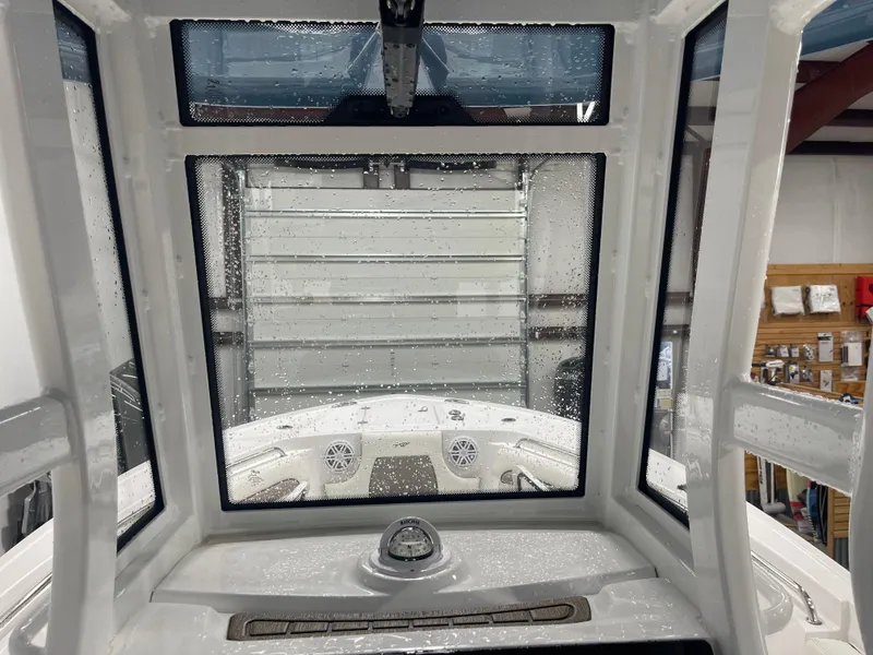 Slide: The Image of Interior view of 2025 Tidewater 232LXF boat with raindrops on windows. - 29