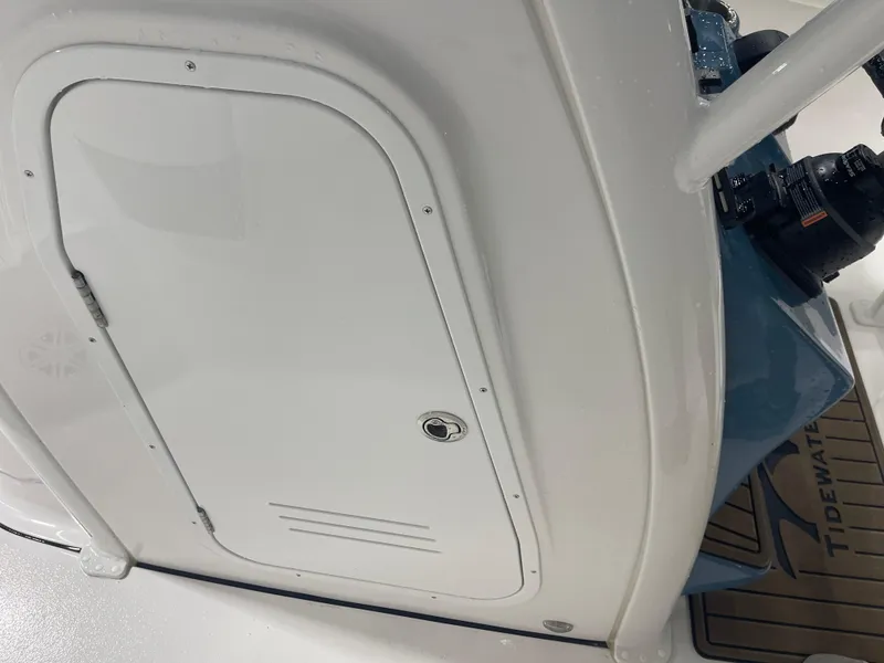 Slide: The Image of 2025 Tidewater 232LXF boat interior with storage compartment and equipment. - 32