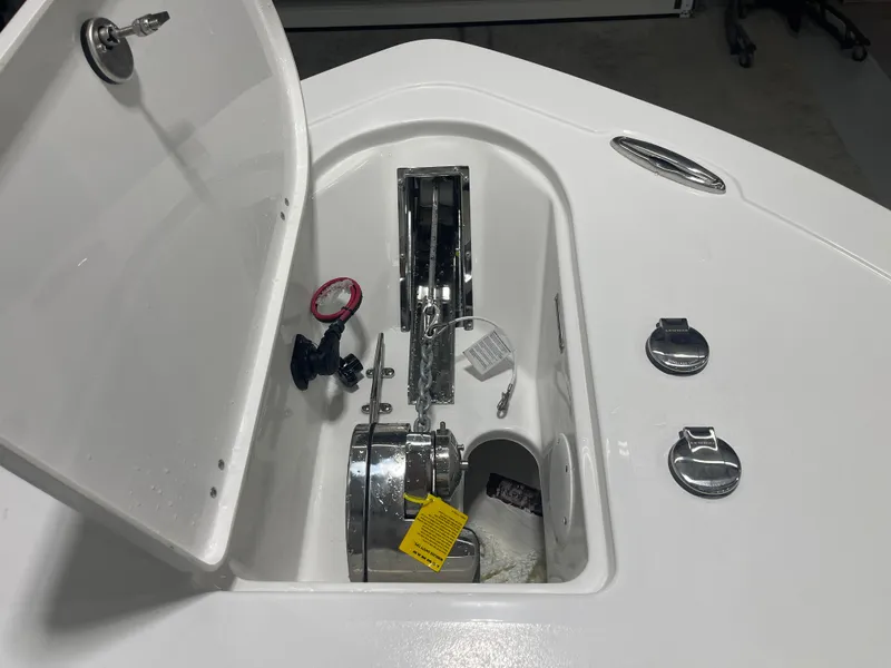 Slide: The Image of Open anchor compartment on 2025 Tidewater 232LXF boat, showcasing anchor mechanism and storage. - 35
