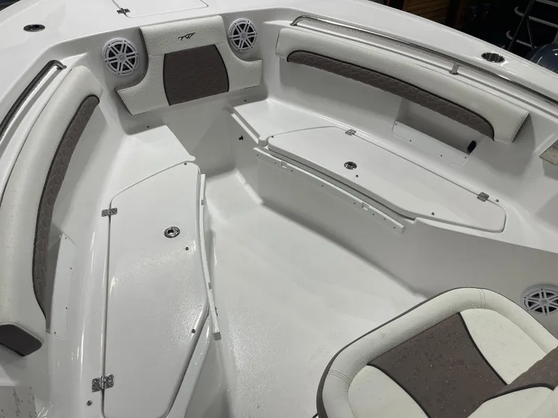 Slide: The Image of 2025 Tidewater 232LXF boat interior with cushioned seating and storage compartments. - 36
