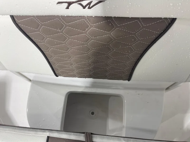 Slide: The Image of 2025 Tidewater 232LXF boat interior with hexagonal-patterned upholstery and storage compartment. - 40