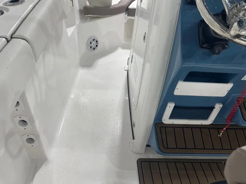 Slide: The Image of 2025 Tidewater 232LXF boat interior with steering console and seating area. - 43