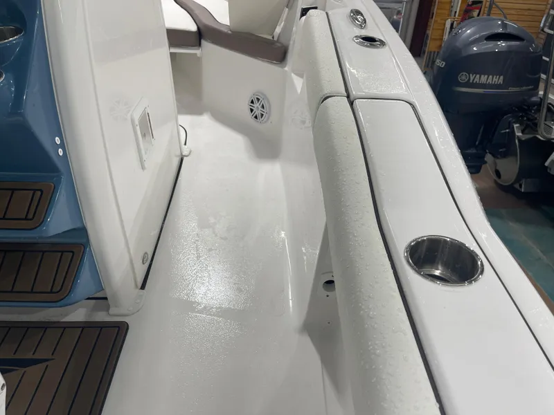 Slide: The Image of 2025 Tidewater 232LXF boat interior with wet deck and Yamaha engine in background. - 44