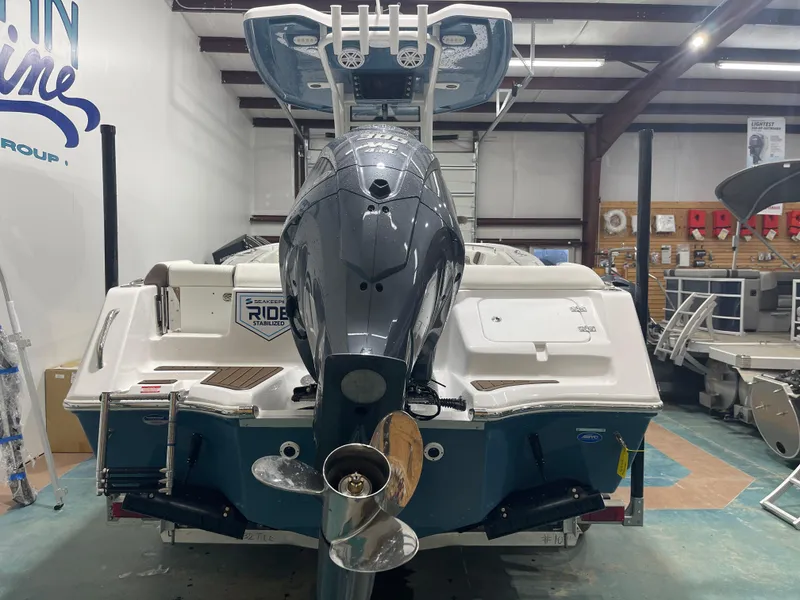 Slide: The Image of 2025 Tidewater 232LXF boat in showroom, featuring powerful outboard motor. - 9