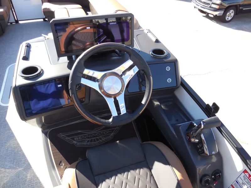 Slide: The Image of 2025 Bennington 26 MSB boat dashboard with modern steering wheel and controls. - 10