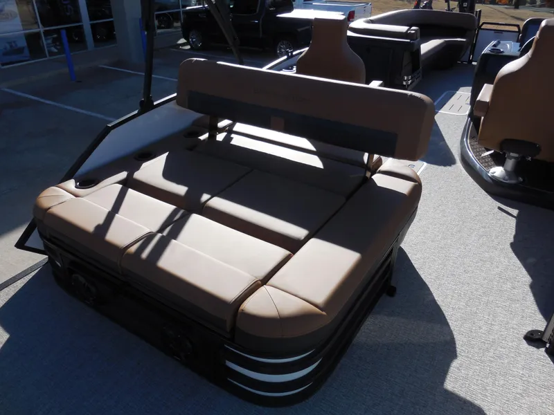 Slide: The Image of 2025 Bennington 26 MSB boat with tan seating in outdoor showroom. - 12