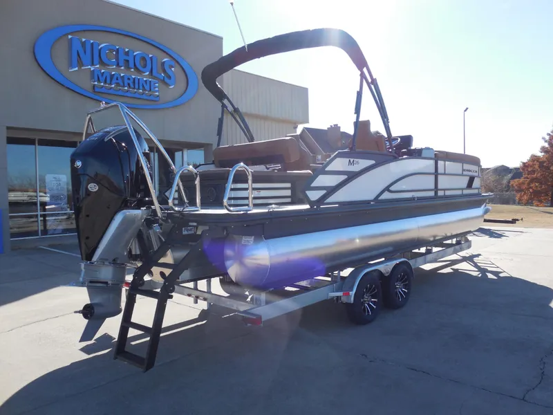 Slide: The Image of 2025 Bennington 26 MSB pontoon boat on trailer at Nichols Marine dealership. - 3