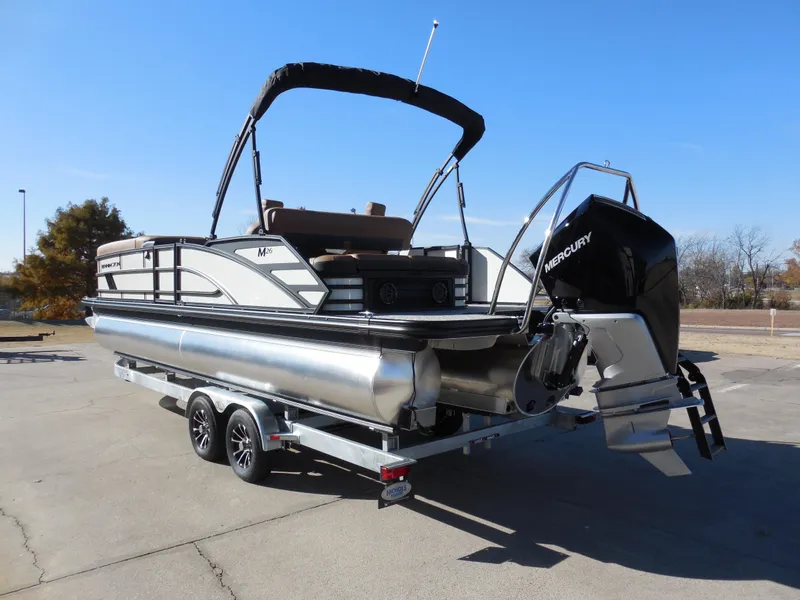 Slide: The Image of 2025 Bennington 26 MSB pontoon boat with Mercury engine on trailer. - 4