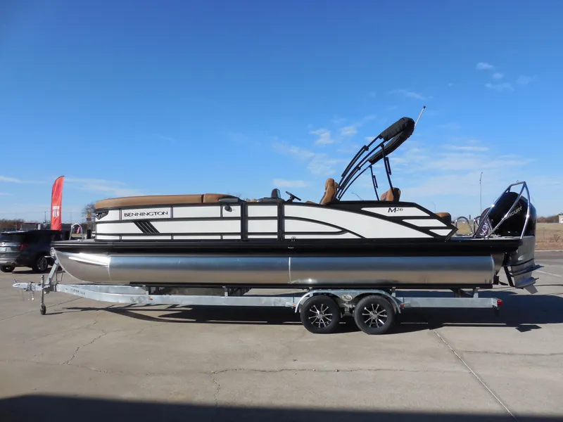 Slide: The Image of 2025 Bennington 26 MSB pontoon boat on trailer under clear blue sky. - 5