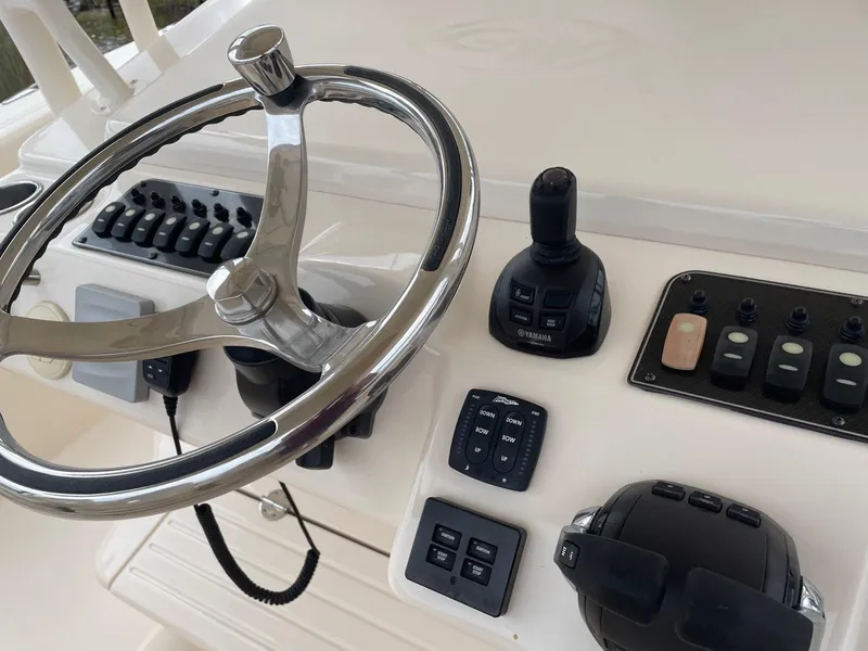 Slide: The Image of Control panel of 2019 Grady-White Canyon 336 boat with steering wheel and switches. - 11