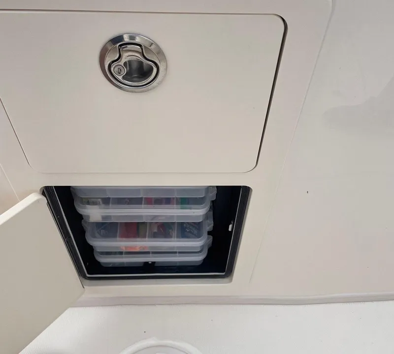 Slide: The Image of Storage compartment on a 2019 Grady-White Canyon 336 boat with organized containers. - 13