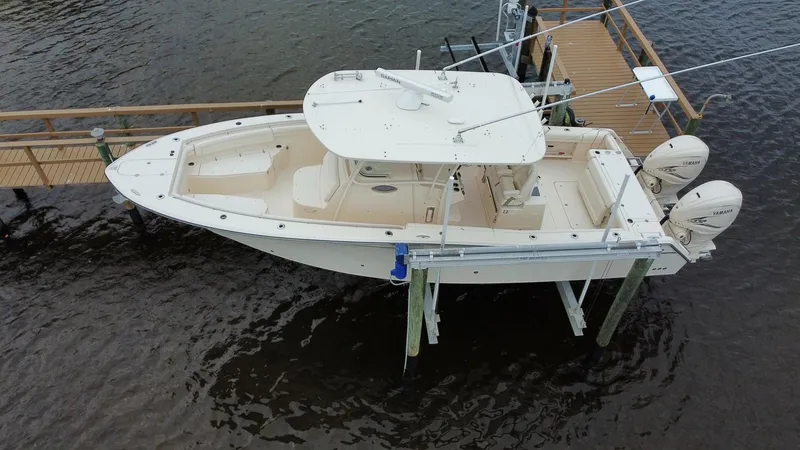 Slide: The Image of 2019 Grady-White Canyon 336 boat docked on water, aerial view. - 18