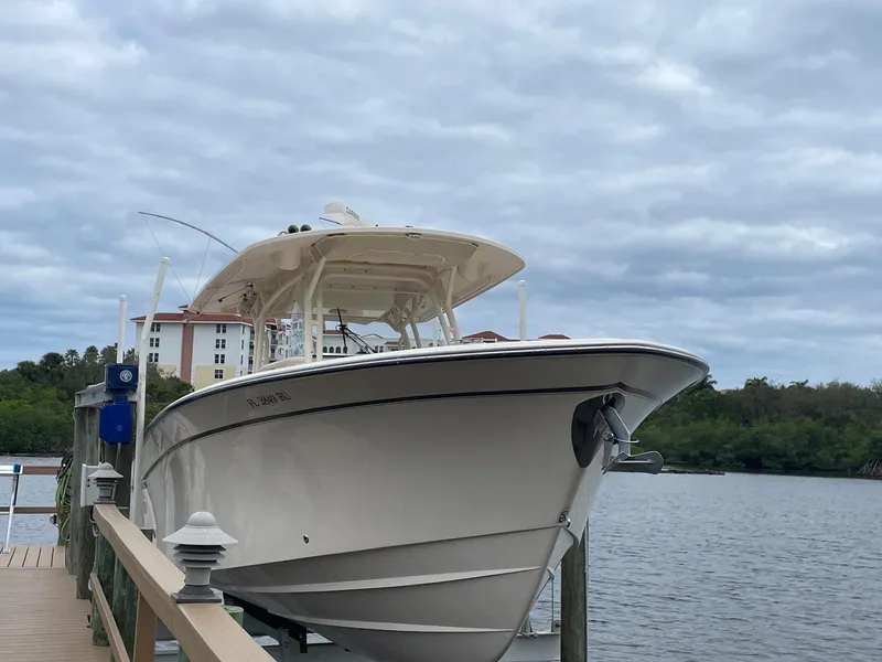 Slide: The Image of 2019 Grady-White Canyon 336 boat docked by a scenic waterfront. - 4