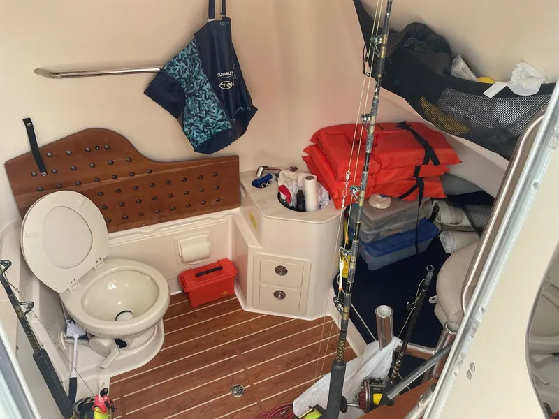 Slide: The Image of 2019 Grady-White Canyon 336 boat cabin with toilet, storage, and fishing gear. - 6