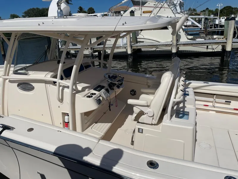 Slide: The Image of 2019 Grady-White Canyon 336 boat docked, featuring spacious seating and helm area. - 7