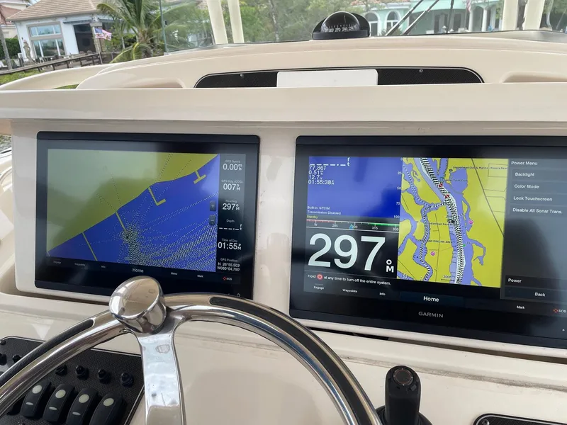 Slide: The Image of Helm of 2019 Grady-White Canyon 336 with dual navigation screens and steering wheel. - 9