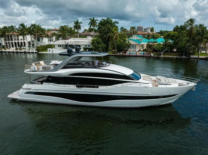 Slide: The Image of Luxurious 2022 Princess Y85 Motor Yacht cruising on a scenic waterway. - 0