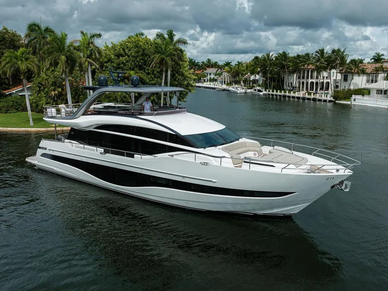 Slide: The Image of Luxurious 2022 Princess Y85 Motor Yacht cruising on a scenic waterway. - 1