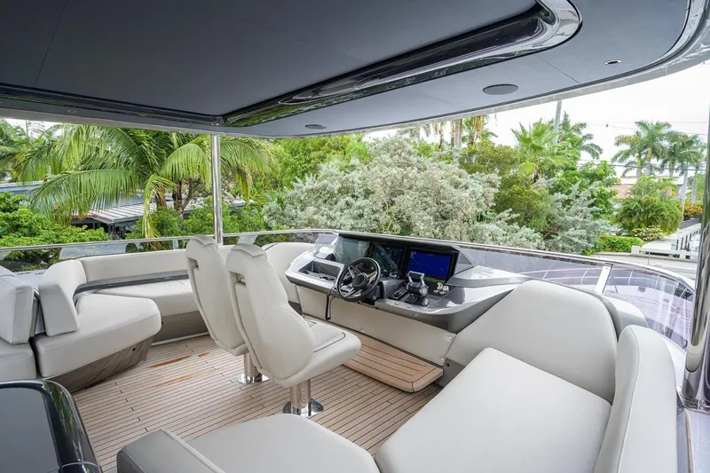 Slide: The Image of Luxurious 2022 Princess Y85 Motor Yacht cockpit with plush seating and modern controls. - 12