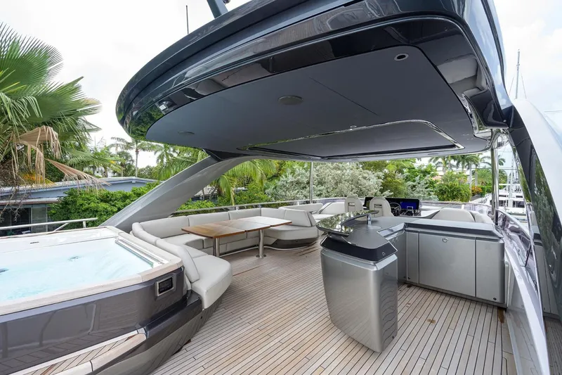 Slide: The Image of Luxurious 2022 Princess Y85 Motor Yacht deck with seating, jacuzzi, and outdoor kitchen. - 13