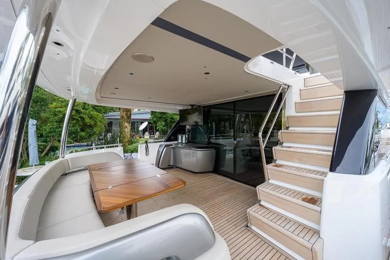 Slide: The Image of Luxurious 2022 Princess Y85 Motor Yacht with elegant outdoor seating and staircase. - 16