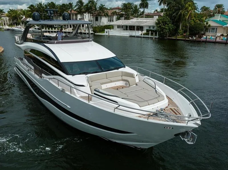 Slide: The Image of 2022 Princess Y85 Motor Yacht cruising on a scenic waterway. - 2