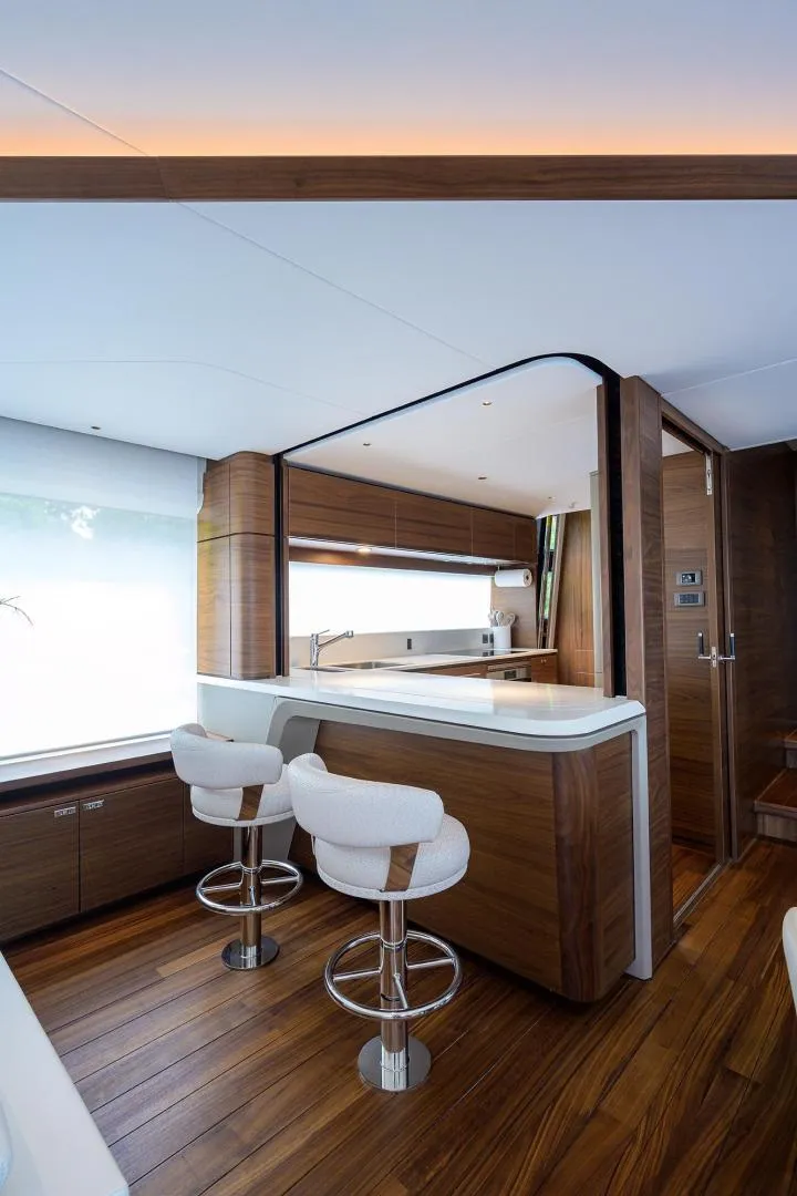 Slide: The Image of Luxurious interior of 2022 Princess Y85 Motor Yacht with modern kitchen and seating. - 24