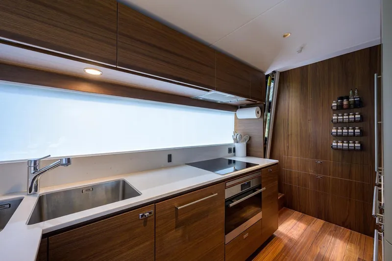 Slide: The Image of Modern kitchen interior on 2022 Princess Y85 Motor Yacht with sleek wood cabinetry. - 26
