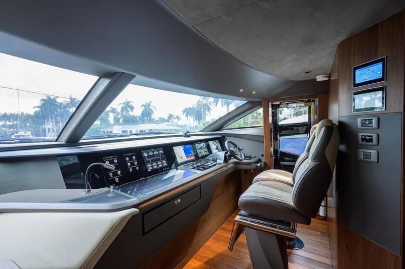 Slide: The Image of Luxurious 2022 Princess Y85 Motor Yacht helm with modern controls and panoramic windows. - 28