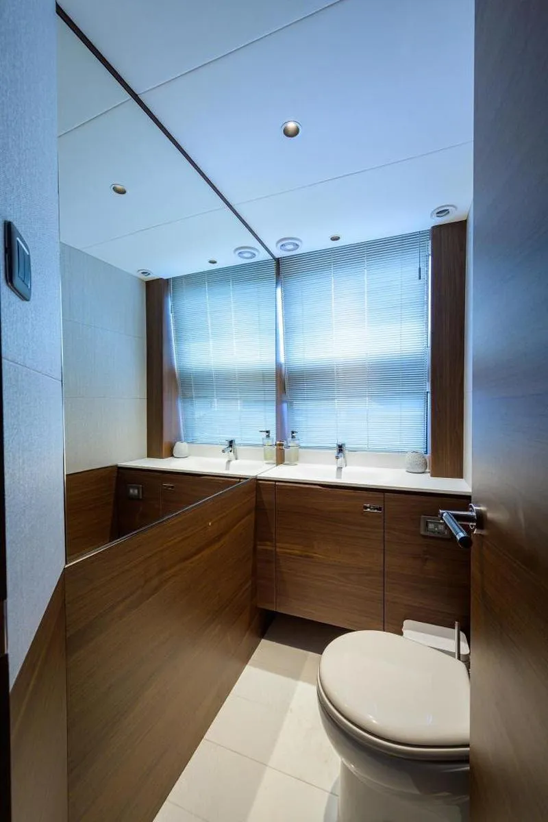 Slide: The Image of Luxurious bathroom on 2022 Princess Y85 Motor Yacht with modern fixtures and wooden cabinetry. - 29