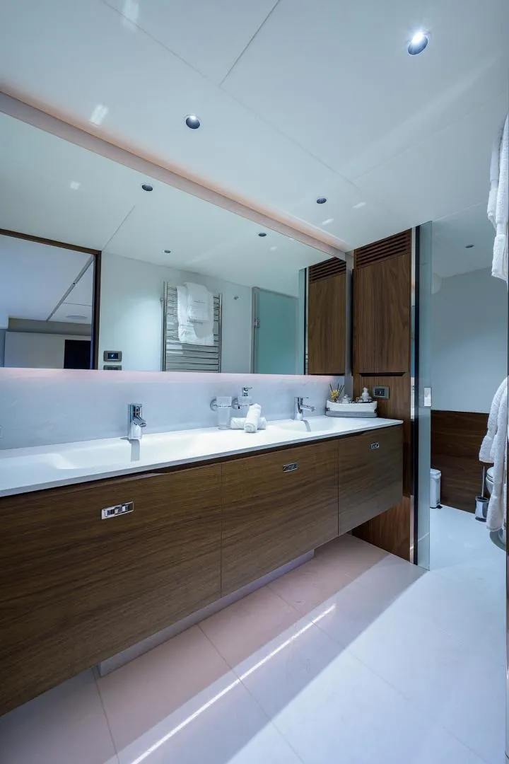 Slide: The Image of Luxurious bathroom in 2022 Princess Y85 Motor Yacht with modern fixtures and wooden cabinetry. - 34