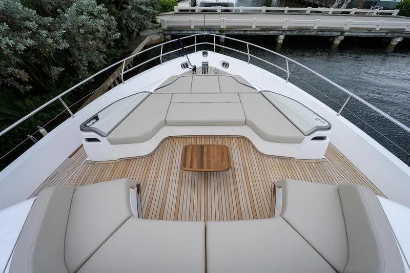 Slide: The Image of Luxurious 2022 Princess Y85 Motor Yacht deck with elegant seating and wooden flooring. - 6